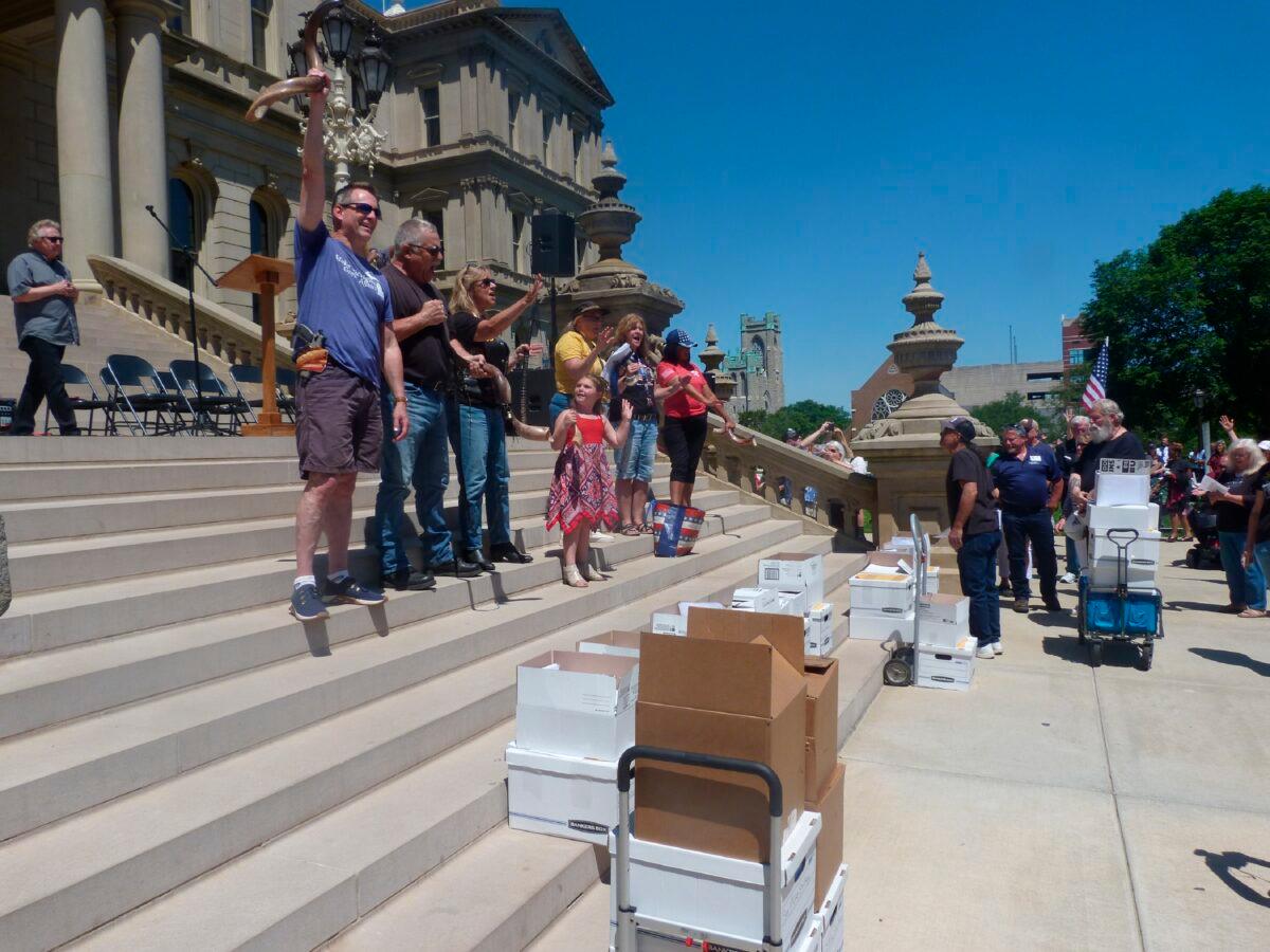 Conservatives gather on the steps of the Michigan Capitol before delivering thousands of affidavits requesting that lawmakers order a forensic audit of the 2020 election in Lansing, Mich., on June 17, 2021. (File photo/David Eggert/AP Photo)