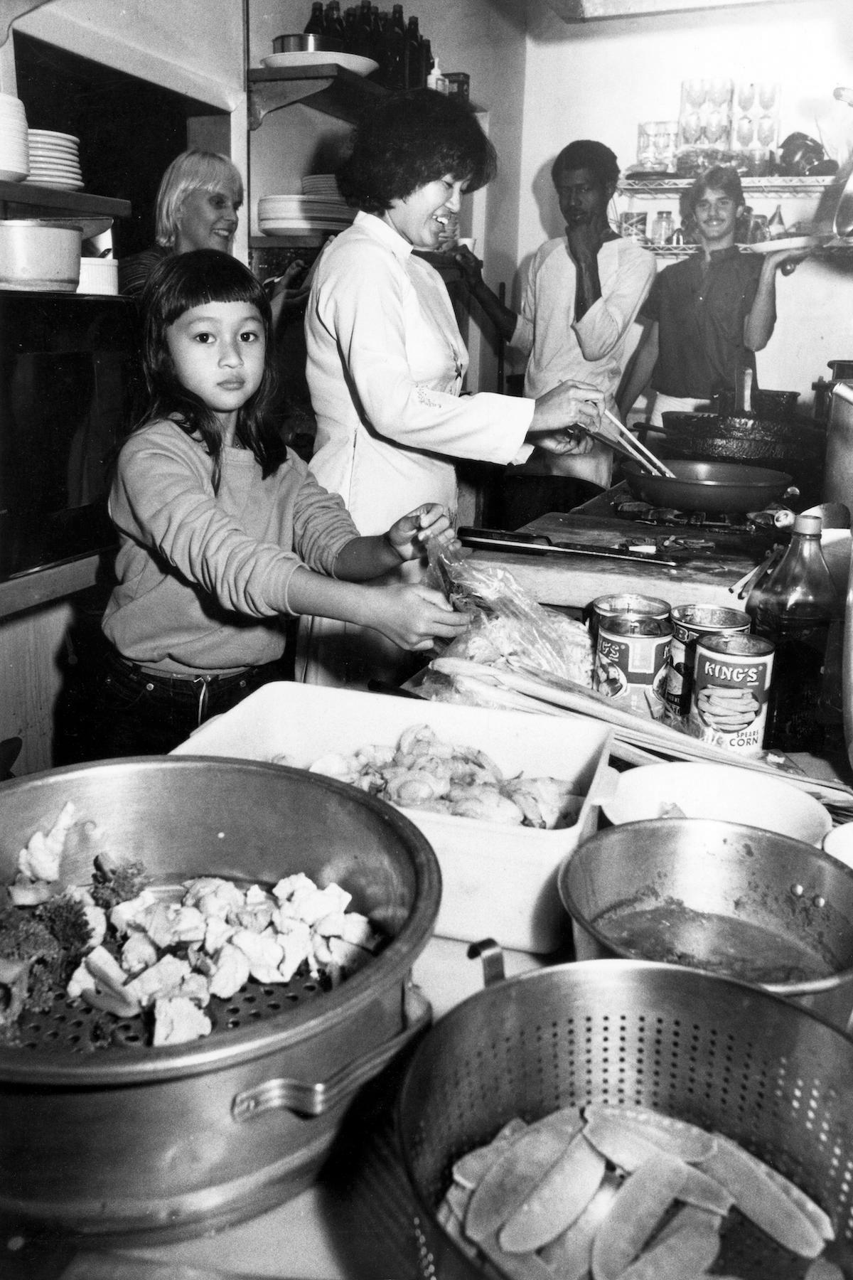 Lyn, Kathy, and Tung cooking at Hy Vong in 1982. (Courtesy of Chronicle Books)