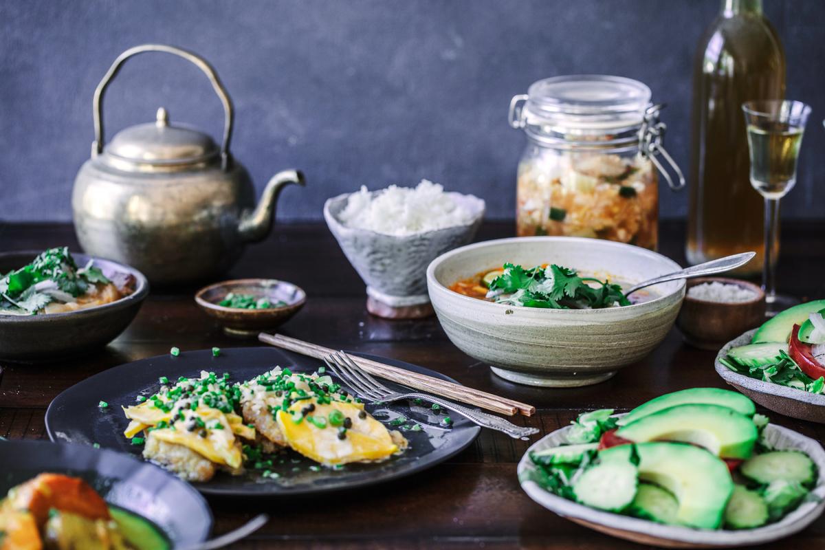 Fish with mango-peppercorn sauce and other favorite dishes from Hy Vong. (Photo by Libby Volgyes/Courtesy of Chronicle Books)
