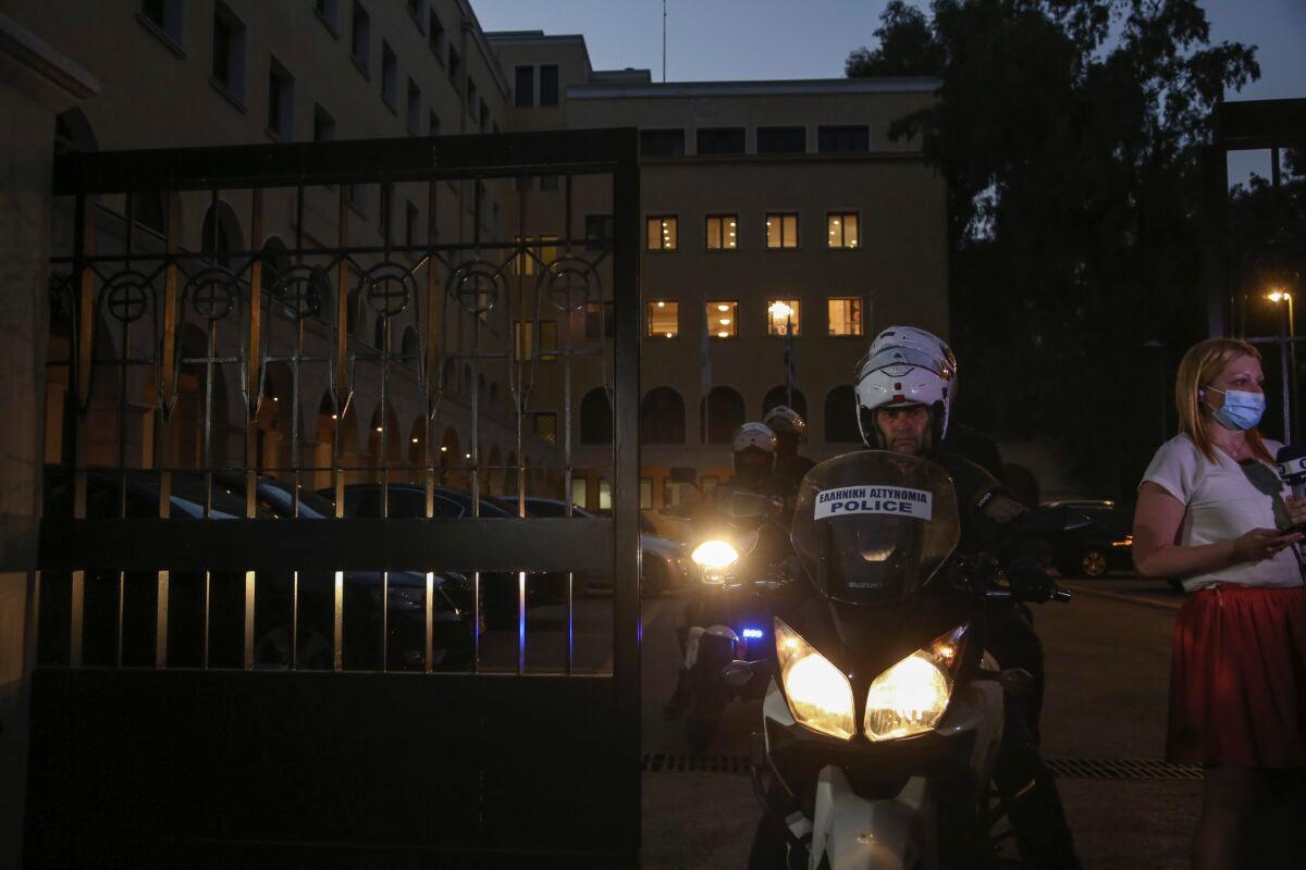 A police officer on a motorcycle exits the Petraki Monastery in Athens, on June 23, 2021. (Petros Giannakouris/AP Photo)
