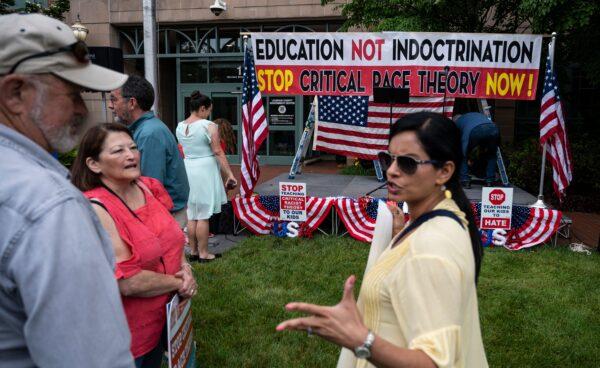 People talk before the start of a rally against "Critical Race Theory" (CRT) being taught in schools, at the Loudoun County Government center in Leesburg, Va., on June 12, 2021. (Andrew Cballlero-Reynolds/AFP via Getty Images)