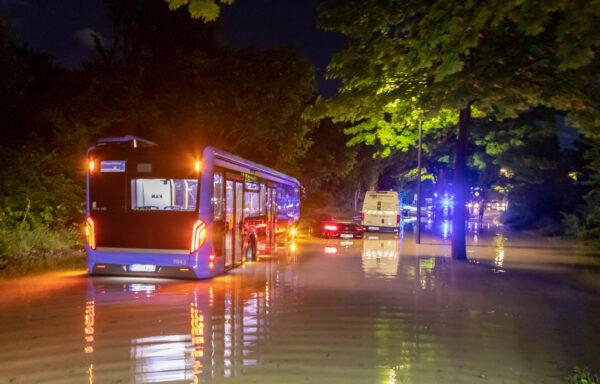 A bus stuck in water on a flooded road in Munich, Germany, on June 23, 2021. (Andre Maerz/dpa via AP)