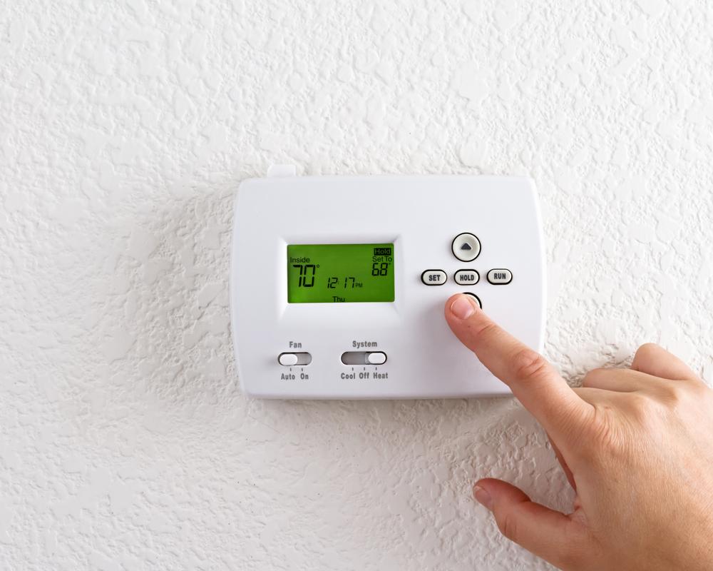 A programmable thermostat lets you set it and forget it. (topseller/Shutterstock)
