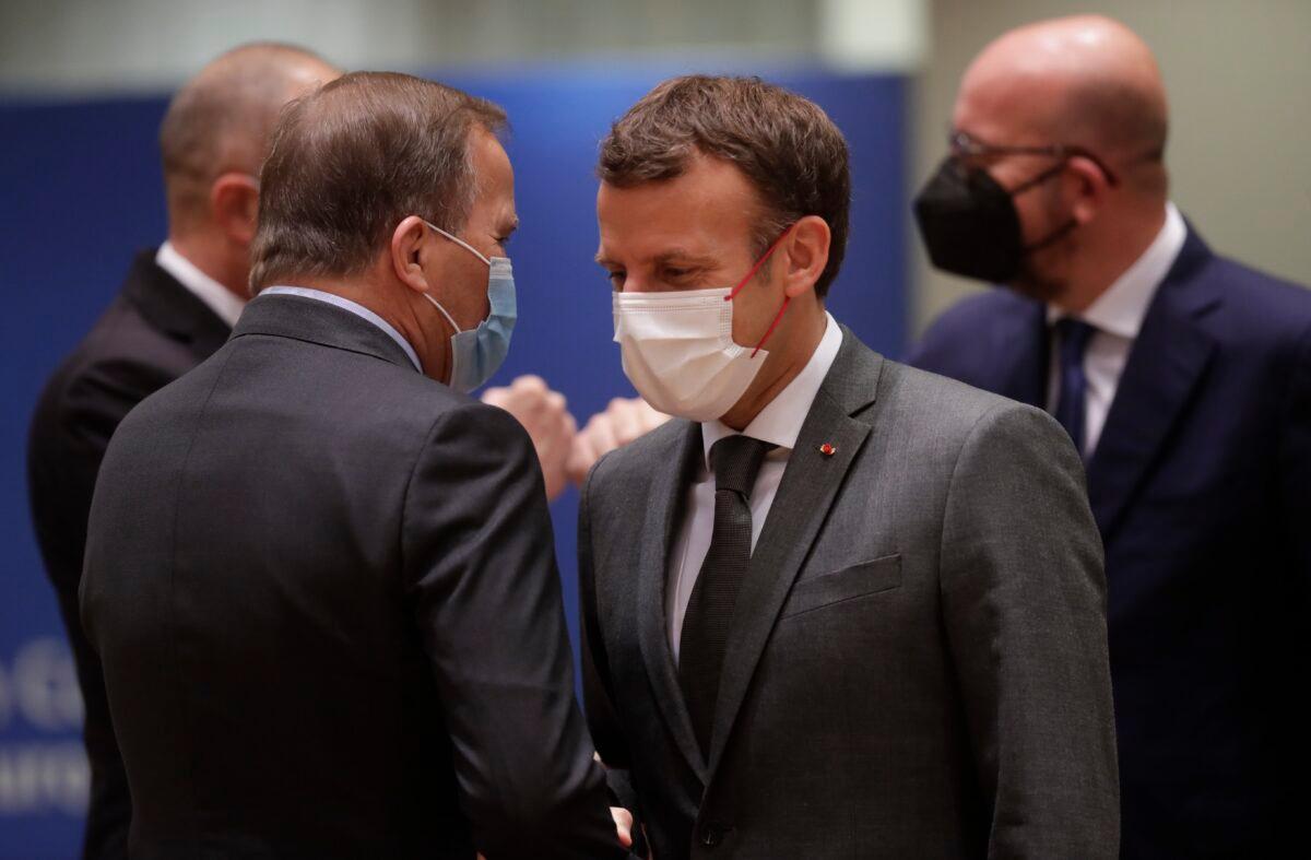 French President Emmanuel Macron, right, talks to Sweden's Prime Minister Stefan Lofven during an EU summit at the European Council building in Brussels, on June 25, 2021. (Olivier Hoslet/Pool Photo via AP)
