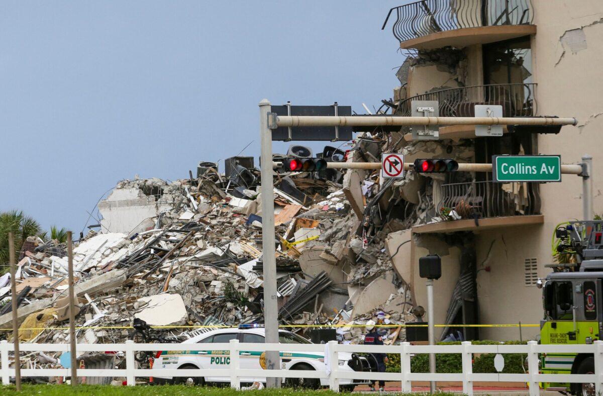 A police car is parked in front of debris from a partially collapsed building in Surfside north of Miami Beach, Fla., on June 24, 2021. (Eva Marie Uzcategui/AFP via Getty Images)