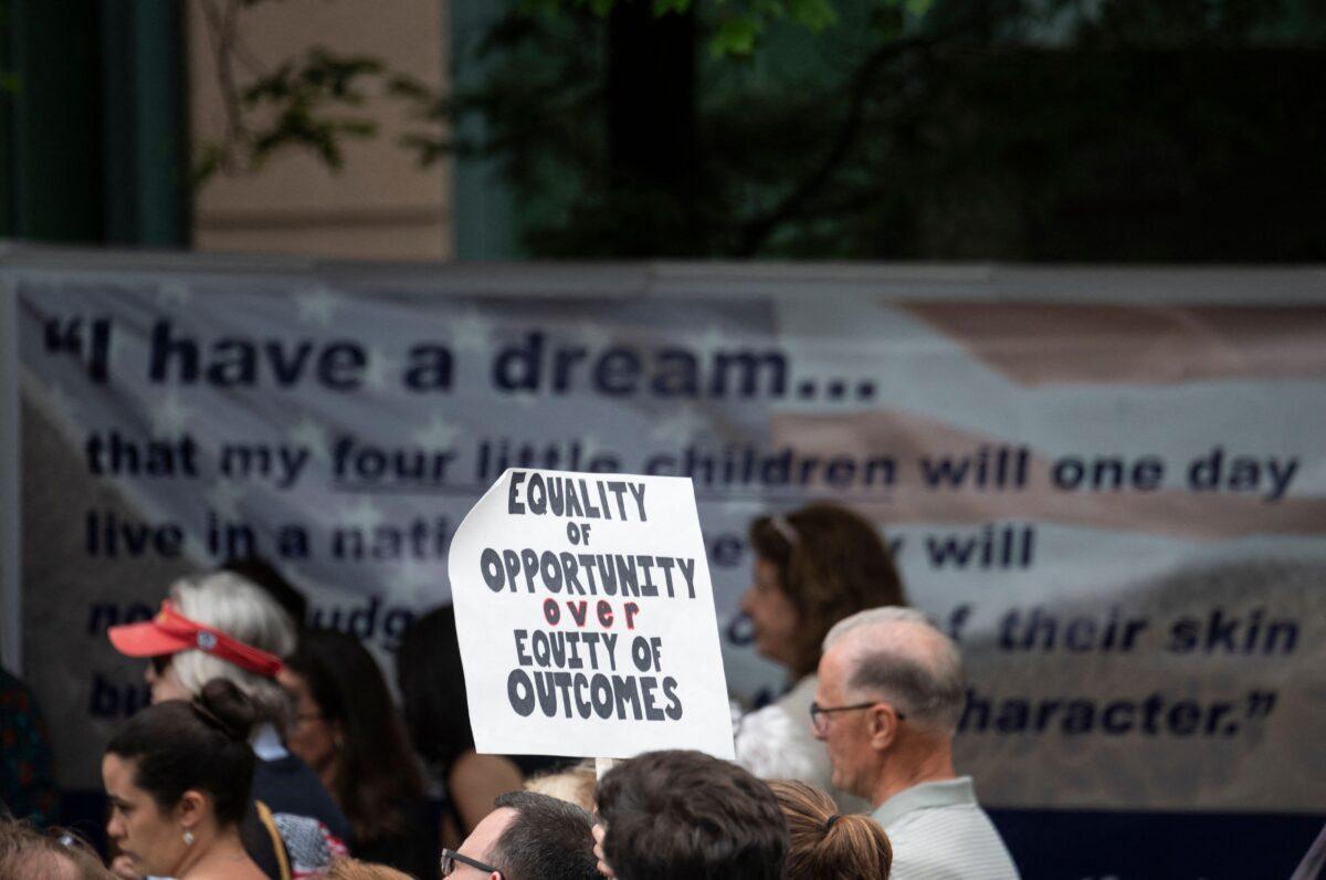 A participant holds up a sign during a rally against critical race theory being taught in schools, at the Loudoun County Government center in Leesburg, Va., on June 12, 2021. (Andrew Caballero-Reynolds/AFP via Getty Images)