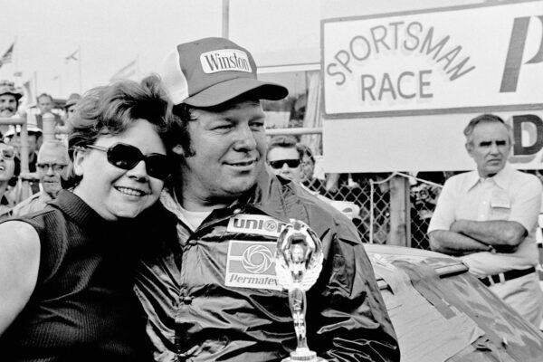 Jack Ingram gives his wife, Aline, a big hug after accepting the trophy from his victory in the Permatex 300 auto race at Daytona International Speedway in Daytona Beach, Fla., on Feb. 15, 1975. (AP/File Photo)