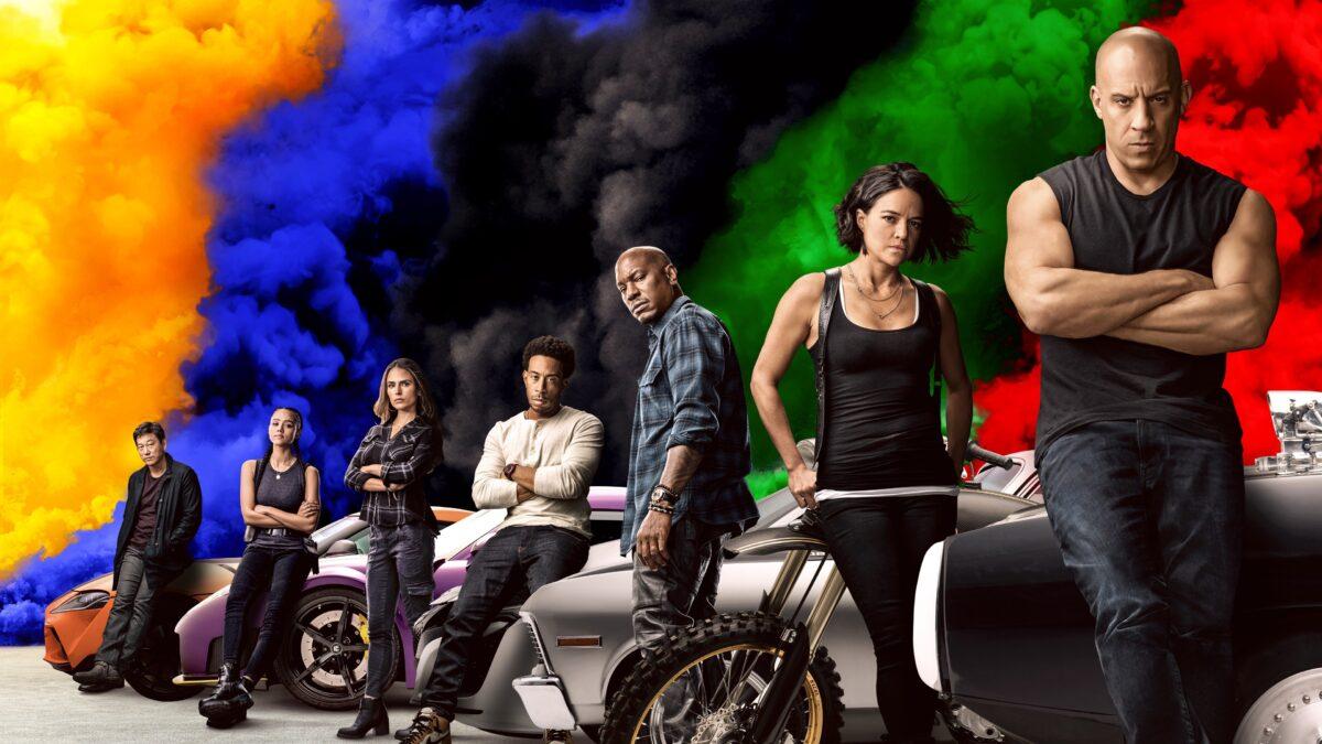 (L–R) Sung Kang, Nathalie Emmanuel, Jordana Brewster, Ludacris, Tyrese Gibson, Michelle Rodriguez, and Vin Diesel in in “F9: The Fast Saga.” (Giles Keyte/Universal)