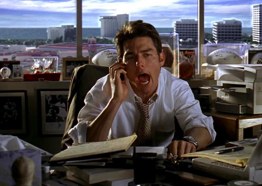 Jerry Maguire (Tom Cruise) hollering "Show me the money!!!" in his office as many co-workers wonder what's going on, in “Jerry Maguire.” (TriStar Pictures)