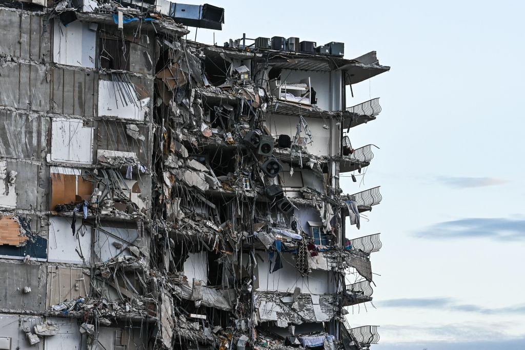 Rubble hangs from a partially collapsed building in Surfside north of Miami Beach, on June 24, 2021. (Chandan Khanna/AFP via Getty Images)