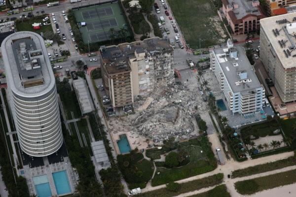 Search and rescue personnel work in the rubble of the 12-story condo tower that crumbled to the ground after a partial collapse of the building in Surfside, Fla., on June 24, 2021. (Joe Raedle/Getty Images)