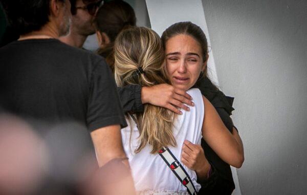Two women comfort each other at the Surfside community center where friends and family of those missing following the collapse of a residential building wait for new developments in the search for their loved ones, in Surfside, Fla., on June 25, 2021. (Jose A. Iglesias/Miami Herald via AP)