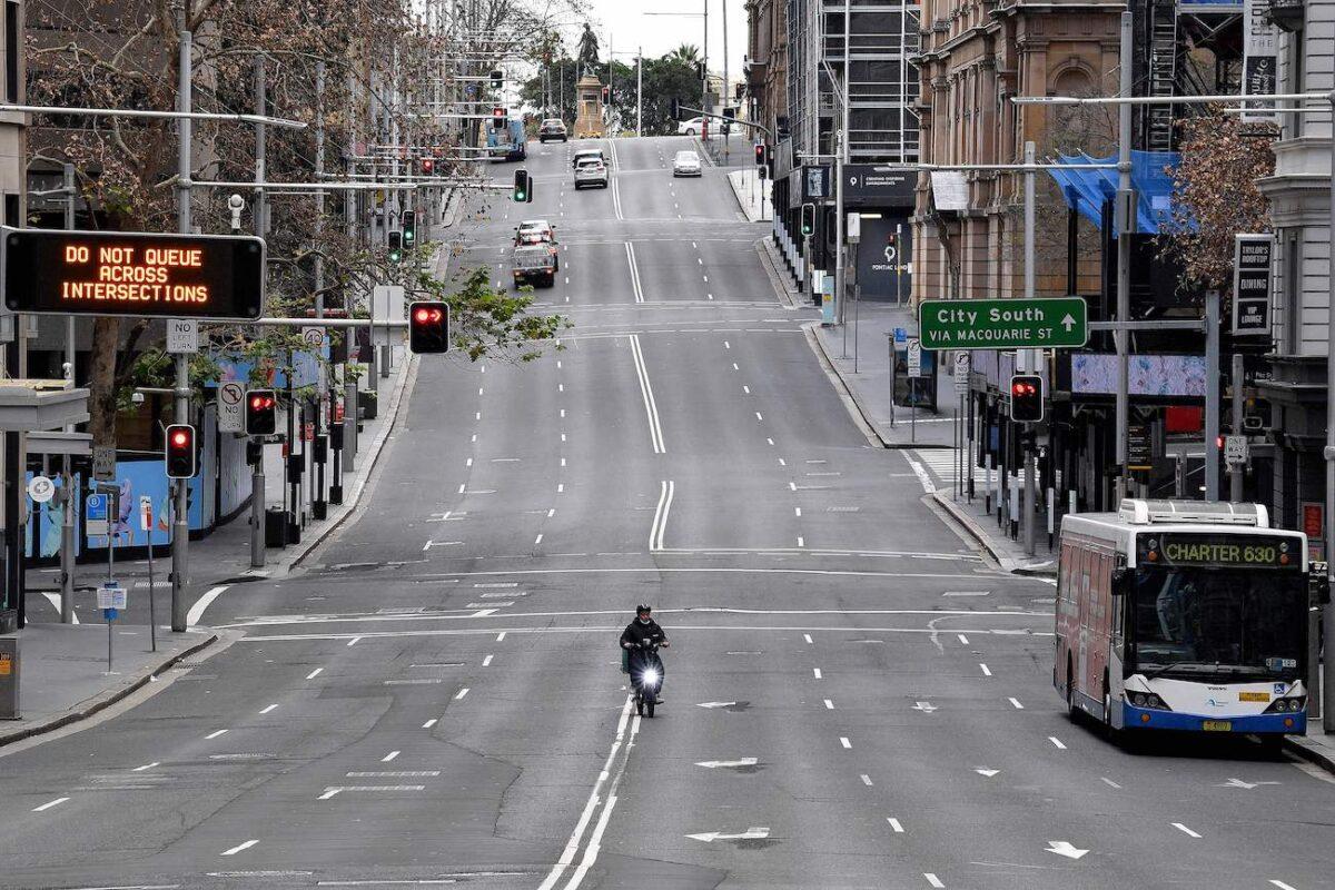 A food delivery worker rides in the central business district of Sydney on Jun. 26, 2021. Australia's largest city entered a two-week lockdown to contain an outbreak of the highly contagious Delta variant. (Saeed Khan/AFP via Getty Images)