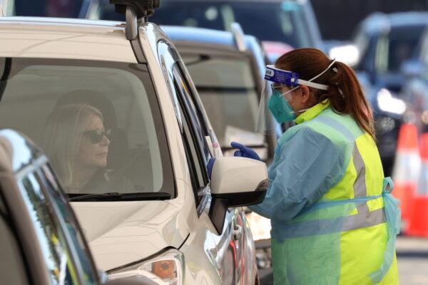 A medical worker prepares to administer a test at the Bondi Beach drive-through COVID-19 testing centre in the wake of new positive cases in Sydney, Australia, June 17, 2021.(Loren Elliott/Reuters)