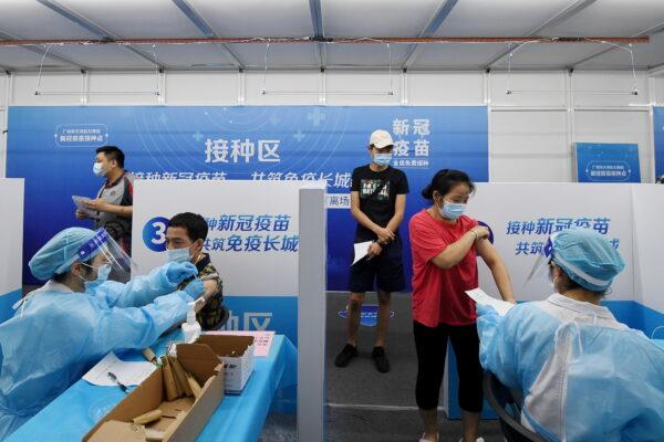 Residents receive COVID-19 vaccines at a makeshift vaccination site in Guangzhou, Guangdong Province, China on June 21, 2021. (Cnsphoto via Reuters)