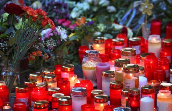 Flowers and candles in front of a closed and cordoned off department store in the city centre of Wuerzburg, Germany, on June 26, 2021. (Karl-Josef Hildenbrand/dpa via AP)