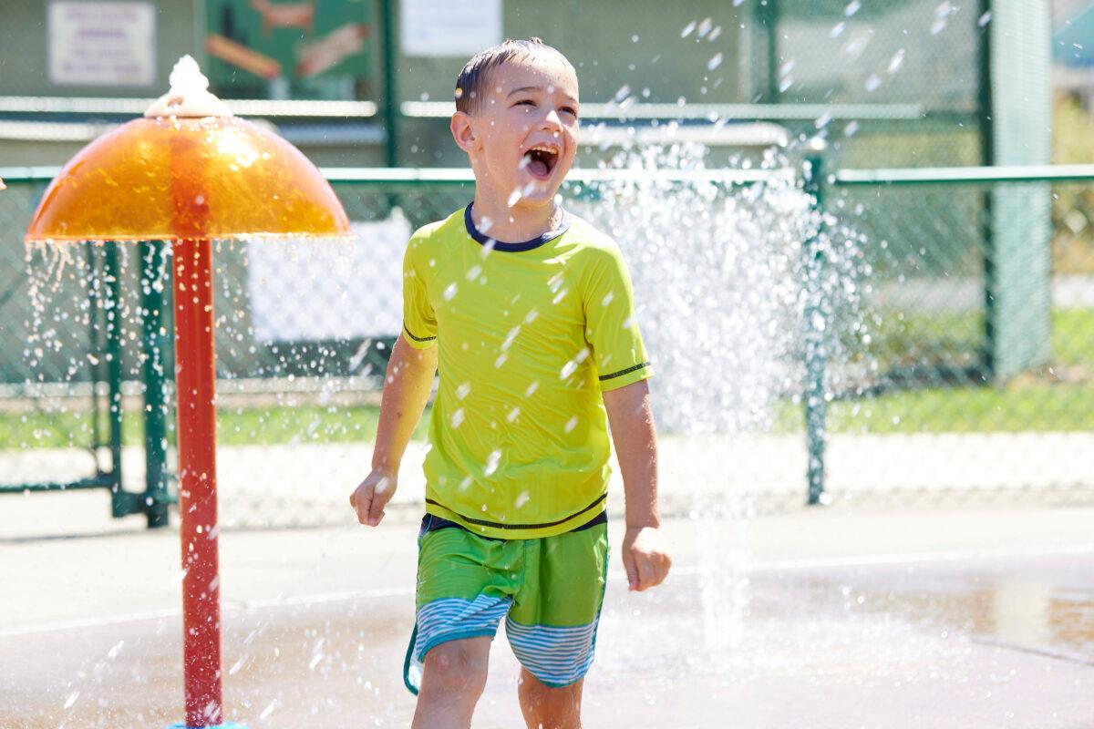 Hunter Sack, 7, runs through the water at Max Patterson Park to escape from the heat during a record heat wave in Gladstone, Ore., on June 27, 2021. (Craig Mitchelldyer/AP Photo)