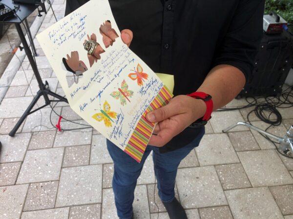 Mike Noriega shows a birthday card relatives sent to his grandmother, Hilda Noriega, two weeks ago for her 92nd birthday, in Surfside, Fla., on June 26, 2021. (Joshua Goodman/AP Photo)