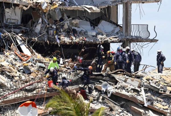 Search and rescue personnel look for survivors through the rubble at the Champlain Towers South in Surfside, Fla., on June 27, 2021. (David Santiago/Miami Herald via AP)
