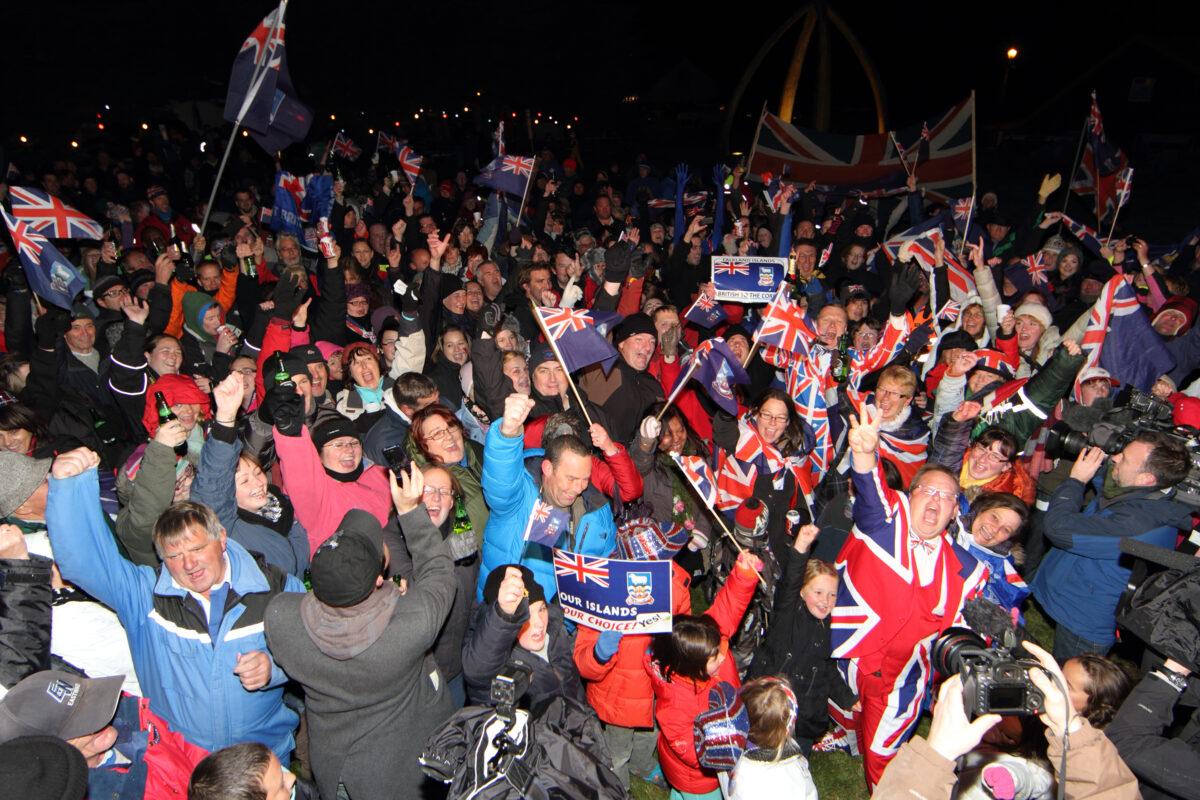 Islanders celebrate after the announcement of the referendum's result in Port Stanley, Falkland Islands, on March 11, 2013. Falkland Islanders made clear their staunch desire to remain British despite Argentina's sovereignty claims. Only three votes out of 1,517 were cast against the islands remaining British. (Tony Chater/AFP via Getty Images)