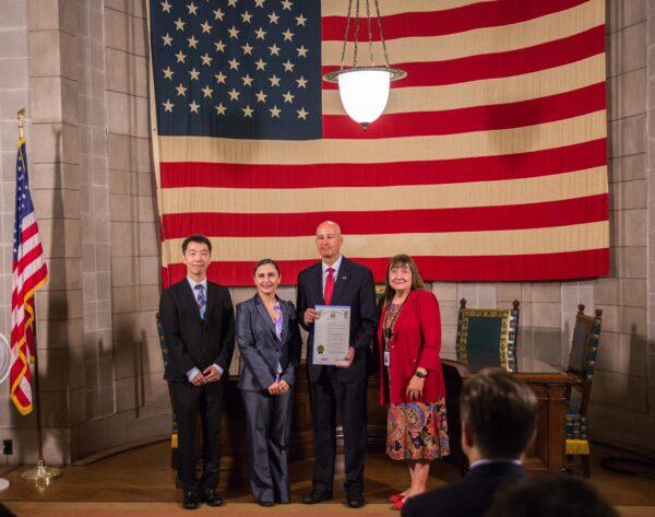 Nebraska Gov. Pete Ricketts (2nd R) with residents who escaped communist oppression, in the state's capitol in Lincoln, Neb., on June 24, 2021. Ricketts proclaimed July a Victims of Communism Remembrance Month. (Petr Svab/The Epoch Times)