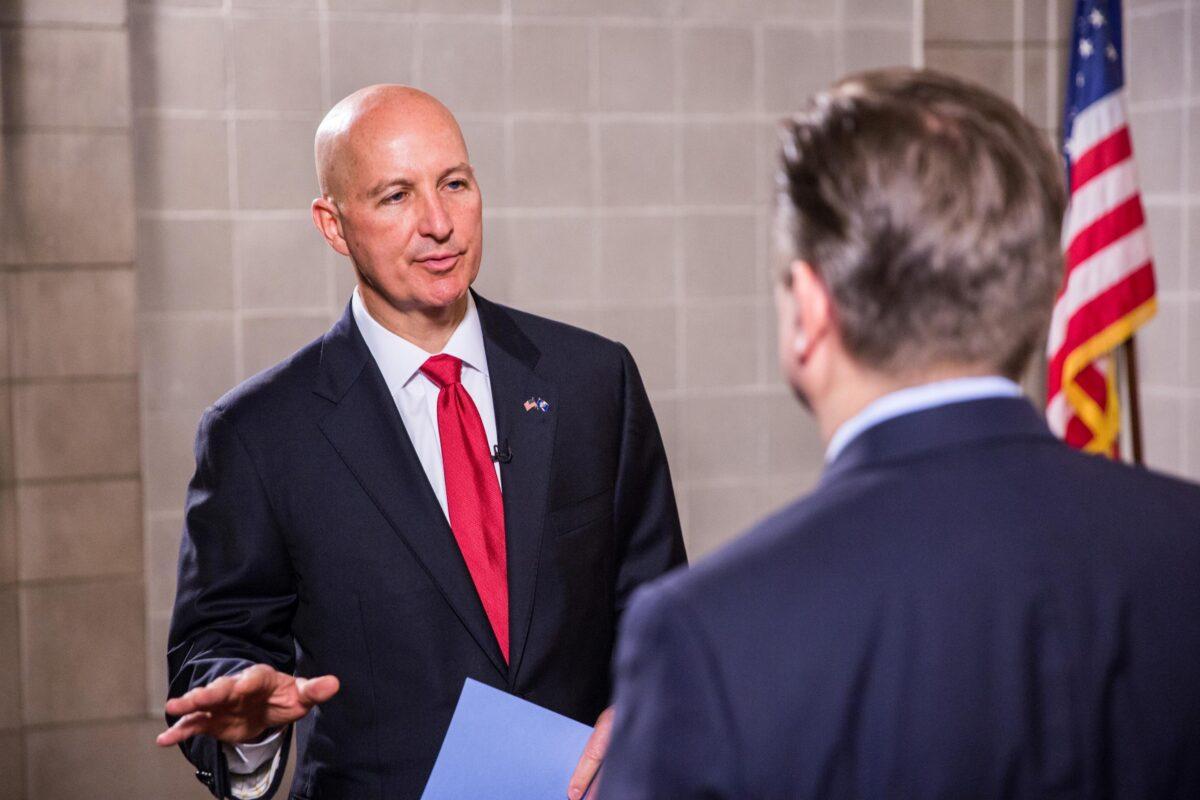 Nebraska Gov. Pete Ricketts (L) and Jan Jekielek, host of The Epoch Times's "American Thought Leaders," in the state's capitol in Lincoln, Neb., on June 24, 2021. (Petr Svab/The Epoch Times)