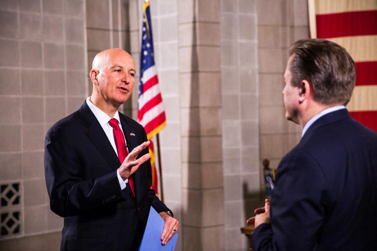 Nebraska Gov. Pete Ricketts (L) and Jan Jekielek, host of The Epoch Times's "American Thought Leaders," in the state's capitol in Lincoln, Neb., on June 24, 2021. (Petr Svab/The Epoch Times)