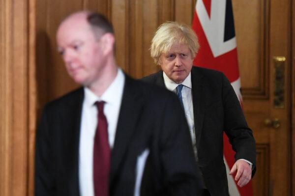 Britain's Prime Minister Boris Johnson (R) and Chief Medical Officer for England Chris Whitty at a Downing Street briefing in London on Feb. 15, 2021. (Stefan Rousseau/POOL/AFP)