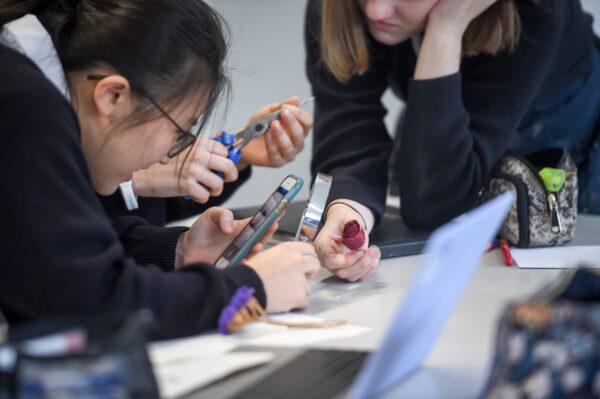 School children looking at smartphones during class in an undated file photo. (Ben Birchall/PA)