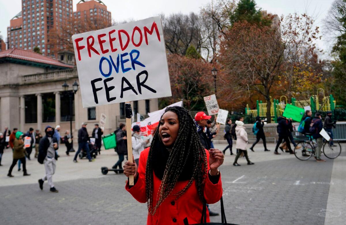 A protestor holds a sign during an anti-lockdown protest in New York City, on Nov. 22, 2020. (Timothy A. Clary/AFP/Getty Images)