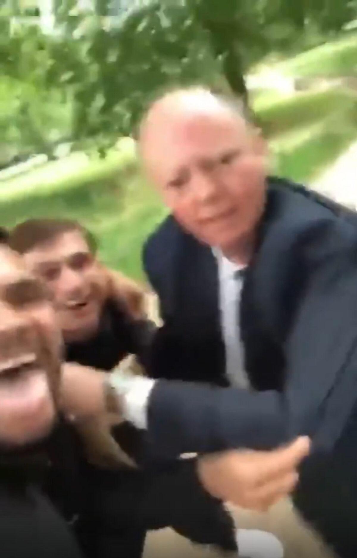 Still taken from video appearing to show professor Chris Whitty, England's chief medical officer, being harassed by two men in a park in London.