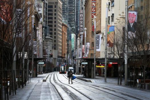 A pedestrian moves along an almost empty George Street in the Sydney CBD, Australia, on June 28, 2021. (Lisa Maree Williams/Getty Images)