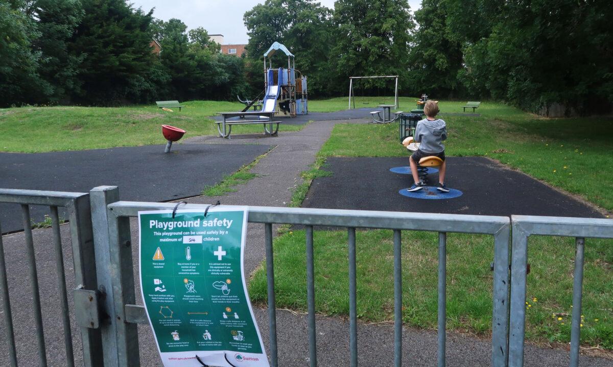 Safety guideline notices are seen at a reopened playground at St Mary's Field in Wallington, England, on July 4, 2020. (Mark Trowbridge/Getty Images)