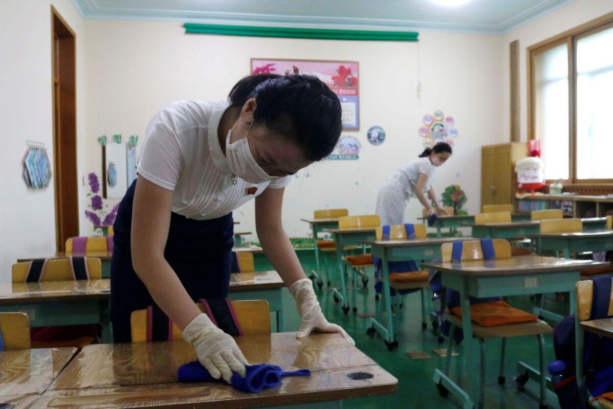 Staff of the Pyongyang Primary School No. 4 clean classroom desks in Pyongyang, North Korea, on June 30, 2021. (Cha Song Ho/AP Photo)