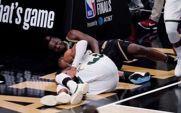 Milwaukee Bucks forward Giannis Antetokounmpo (L) and Atlanta Hawks center Clint Capela fall to the court during the second half of Game 4 of the NBA basketball Eastern Conference finals in Atlanta, on June 29, 2021. (Brynn Anderson/AP Photo)