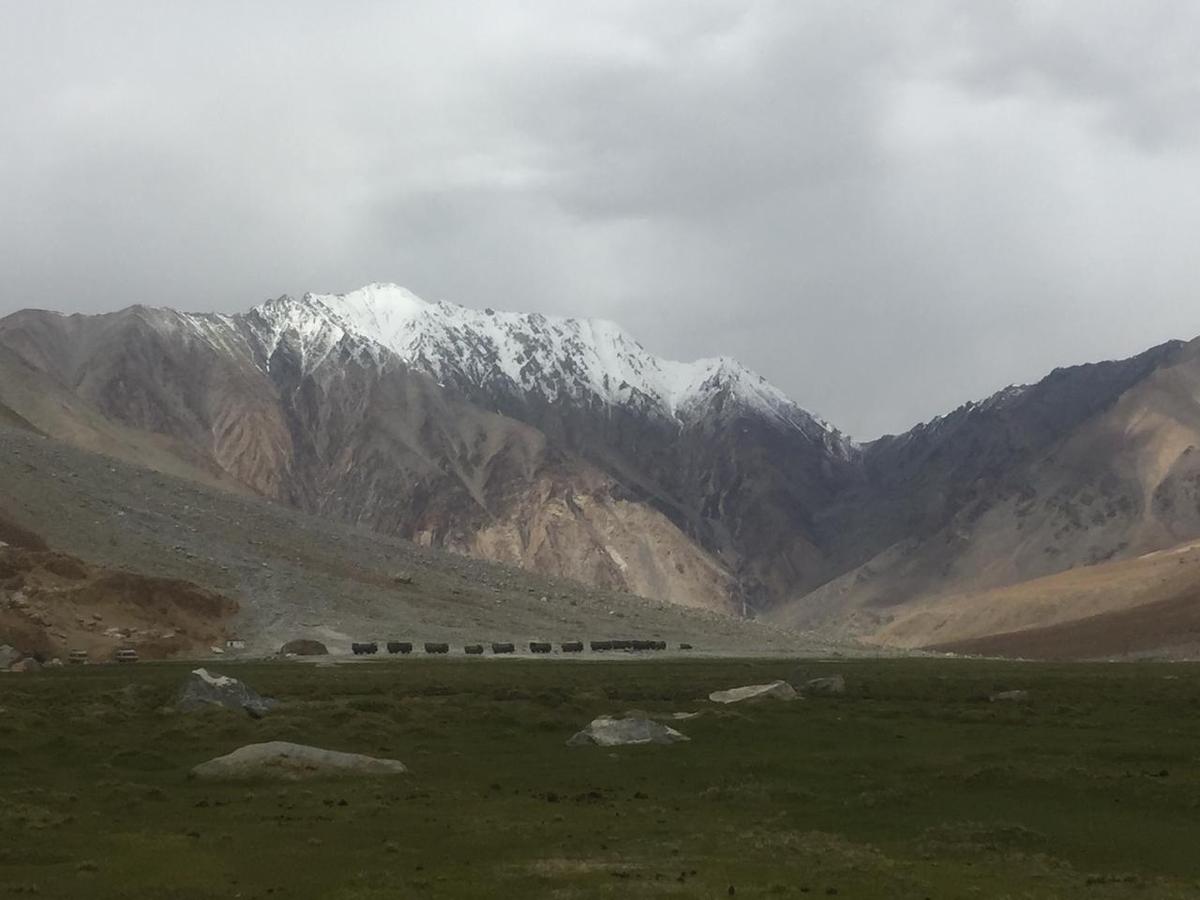 A row of army trucks on the high mountain roads of Ladakh, en route from Leh city to Pangong Tso lake on June 22, 2021. (Venus Upadhayaya/The Epoch Times)