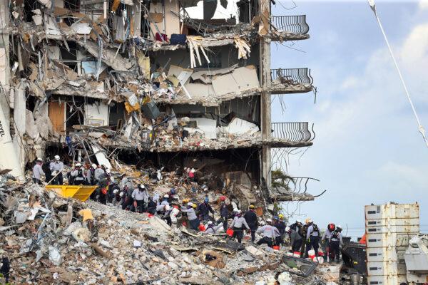 Search and rescue teams look for possible survivors and to recover remains at the site of the 12-story oceanfront Champlain Towers South Condo, at 8777 Collins Ave., that partially collapsed in Surfside, Fla., on June 29, 2021. (Mike Stocker/Sun Sentinel/TNS)
