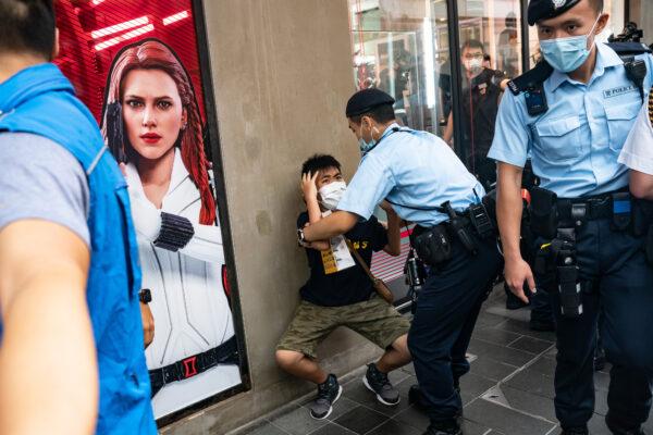 A child is detained by police officers on the 24th anniversary of Hong Kong's handover from Britain in the Causeway Bay district in Hong Kong on July 1, 2021. (Anthony Kwan/Getty Images)