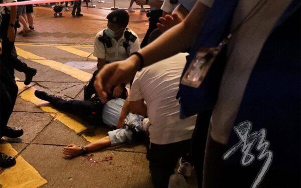 A policeman is lying on the ground after being stabbed on his back in Hong Kong on July 1, 2021. (Provided to The Epoch Times by Bai Ying)