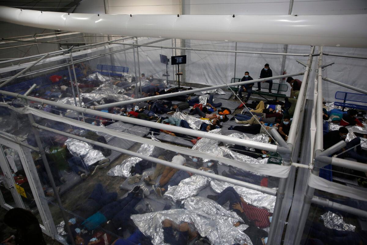 Young children lie inside a pod at the Department of Homeland Security holding facility run by the Customs and Border Patrol (CBP) in Donna, Texas, on March 30, 2021. (Dario Lopez-Mills/ Pool/Getty Images)