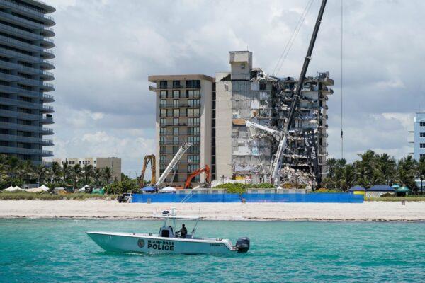 A Miami-Dade County Police boat patrols in front of the Champlain Towers South condo building, where search and rescue efforts continue more than a week after the building partially collapsed, in Surfside, Fla., on July 2, 2021. (Mark Humphrey/AP Photo)