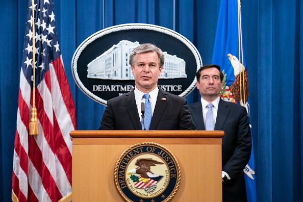 FBI Director Christopher Wray speaks during a virtual news conference at the Department of Justice in Washington on Oct. 28, 2020. Five Chinese agents were arrested in the United States for their role in an operation targeting opponents of the Chinese regime. Then-Assistant Attorney General John Demers said charges had been filed against eight people involved in an "illegal Chinese law enforcement operation known as Fox Hunt." (Sarah Silbiger/AFP via Getty Images)