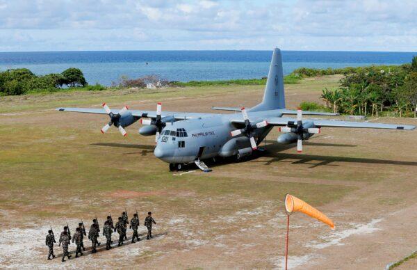 A Philippine air force C-130 transport plane as Philippines troops march at the Philippine-claimed Thitu Island off the disputed Spratlys chain of islands in the South China Sea in western Philippines, on April 21, 2017. (Bullit Marquez/File/AP Photo)