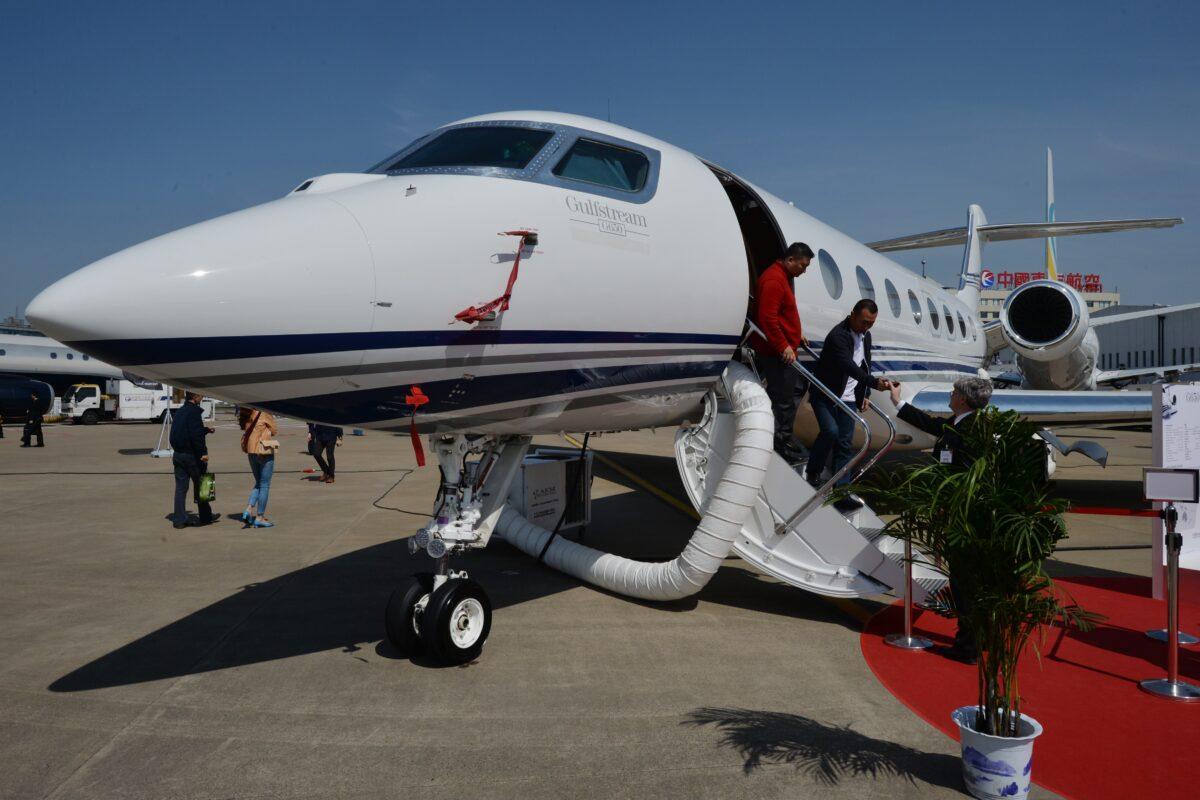 Chinese businessmen leave a Gulfstream G650 luxury business jet during the Asian Business Aviation Conference and Exhibition (ABACE2014) at the Shanghai Hongqiao airport on April 15, 2014. (Mark Ralston/AFP via Getty Images)