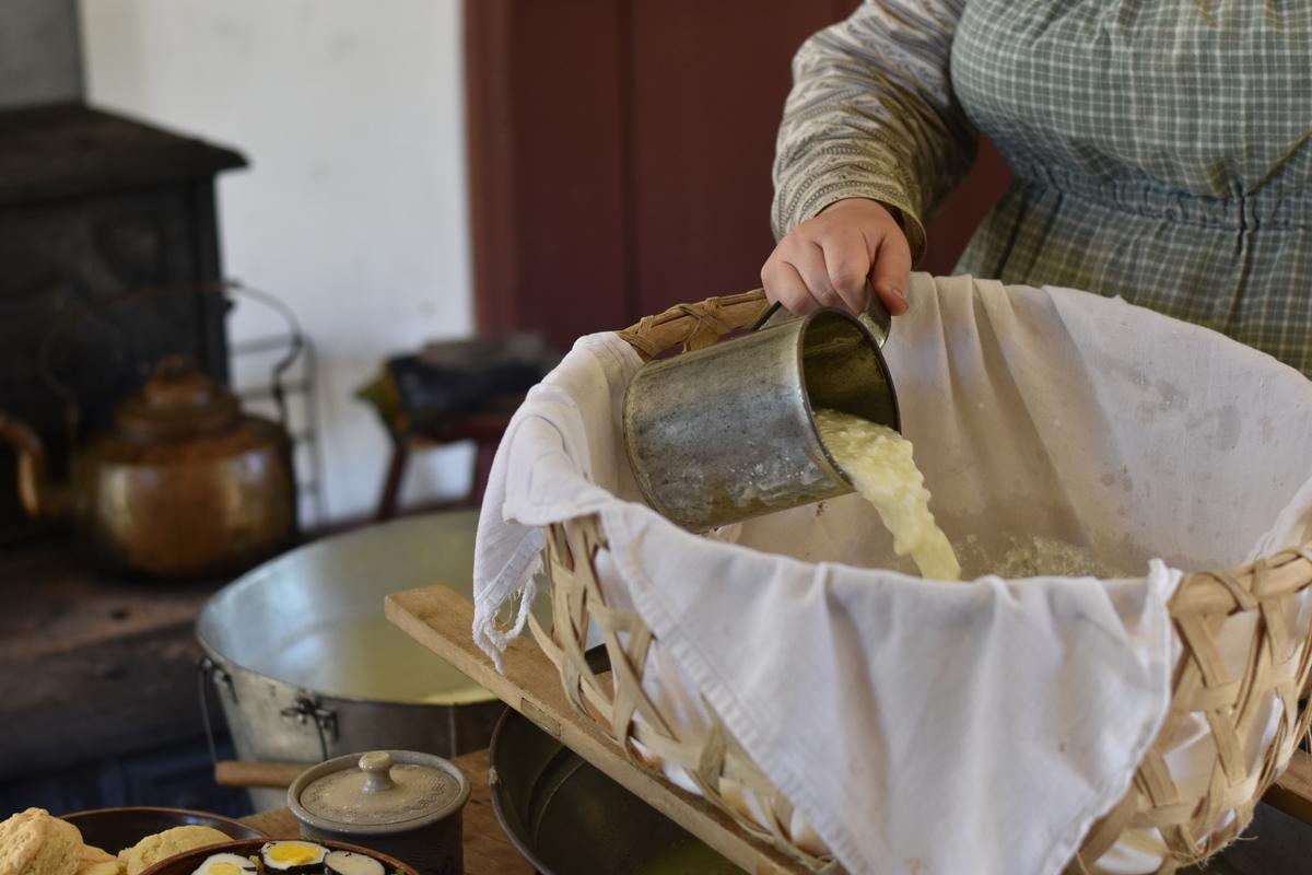 The traditional process of separating curds from whey is demonstrated at Jones Farm at Genesee Country Village & Museum. (Courtesy of Genesee Country Village & Museum)