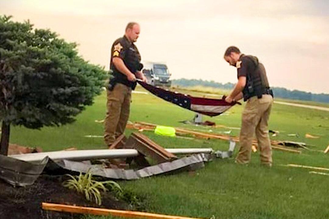 Stirring Photos Show Sheriff’s Deputies Folding American Flag Amidst Rubble After Storm Hits Homes