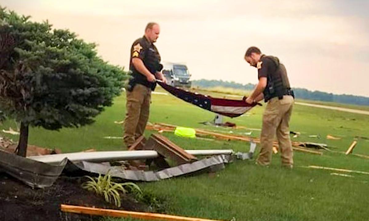 Stirring Photos Show Sheriff’s Deputies Folding American Flag Amidst Rubble After Storm Hits Homes