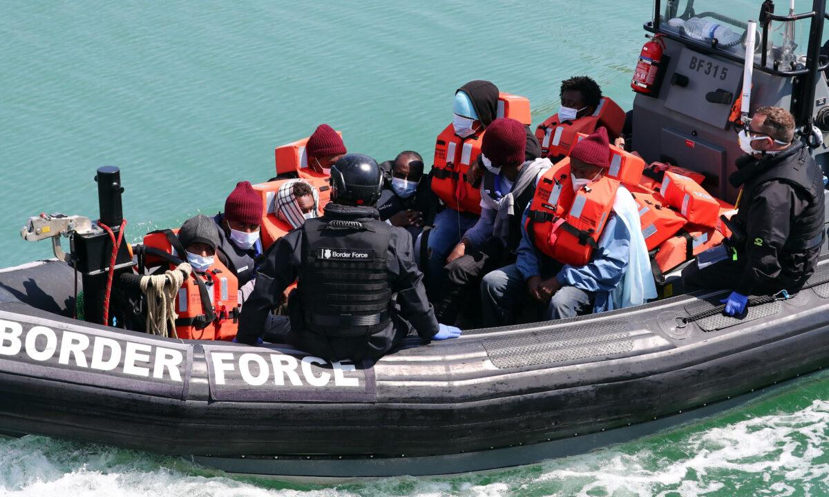 A group of people thought to be illegal immigrants are brought into Dover, Kent, following a small boat incident in the Channel on June 6, 2021. (Gareth Fuller/PA Media)