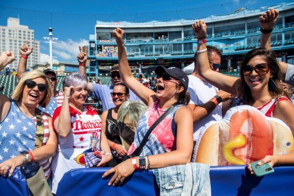 Fans cheer on contestant Larell Marie Mele (L) before going onstage at the Nathan's Famous Fourth of July International Hot Dog-Eating Contest in Coney Island's Maimonides Park in the Brooklyn borough of New York City, on July 4, 2021. (Brittainy Newman/AP Photo)
