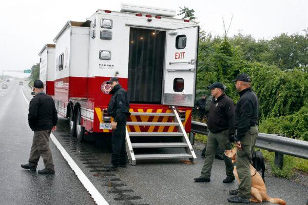 Police work on in the area of an hours long standoff with a group of armed men that partially shut down interstate 95, in Wakefield, Mass., on July 3, 2021. (Michael Dwyer/AP Photo)